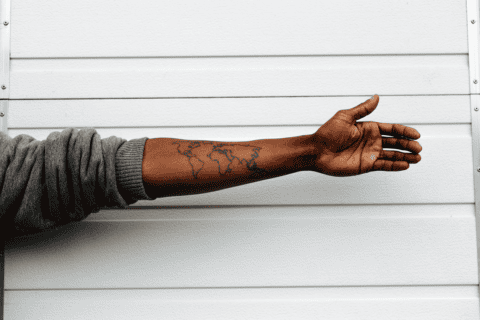 Extended arm with tattoo