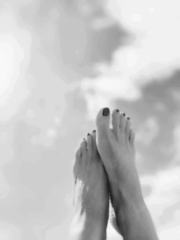 A black and white picture of a feet with clean and polished toenails