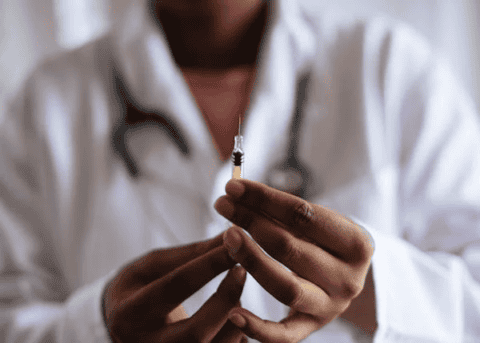 Syringe with bead of liquid