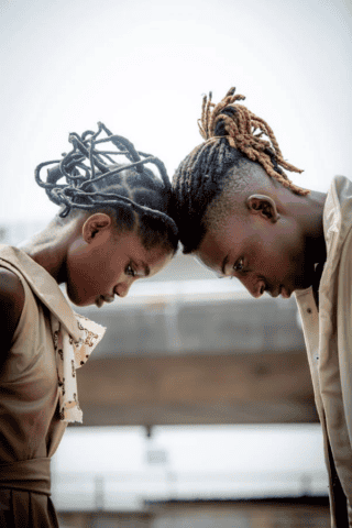 Individuals with locs looking down
